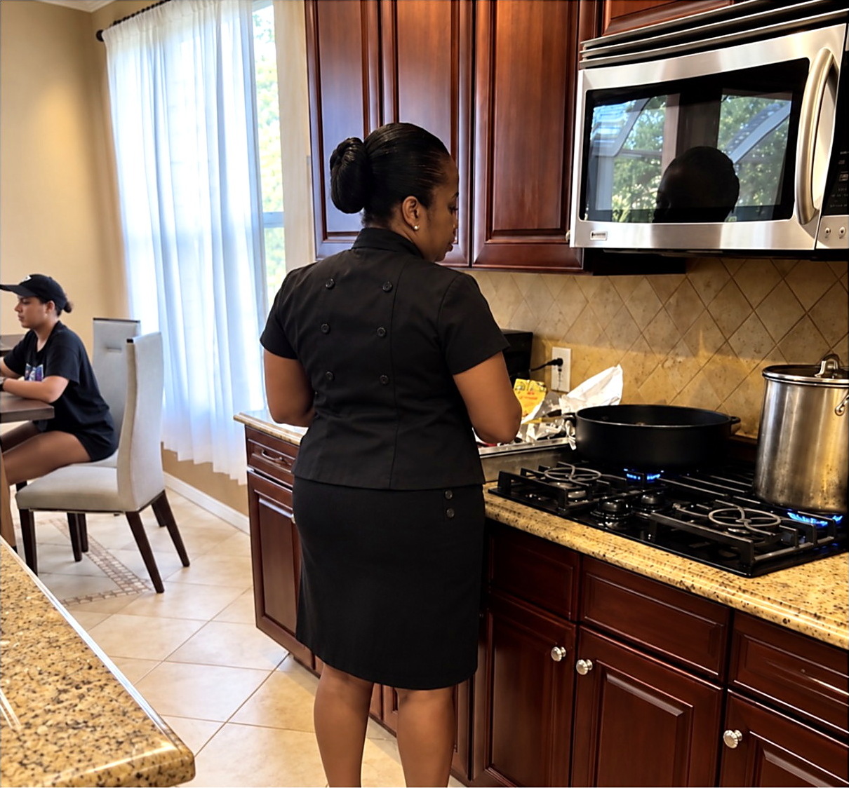 Chef Candy cooking at a home stove during an on-site private dinner